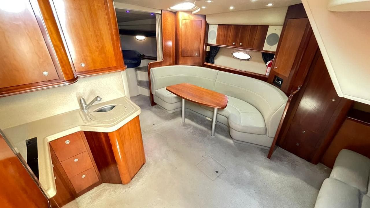 Indoor kitchen with sink, cabinets, and dining area.