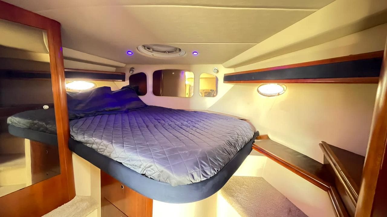 Cabin with a double bed dressed in gray.