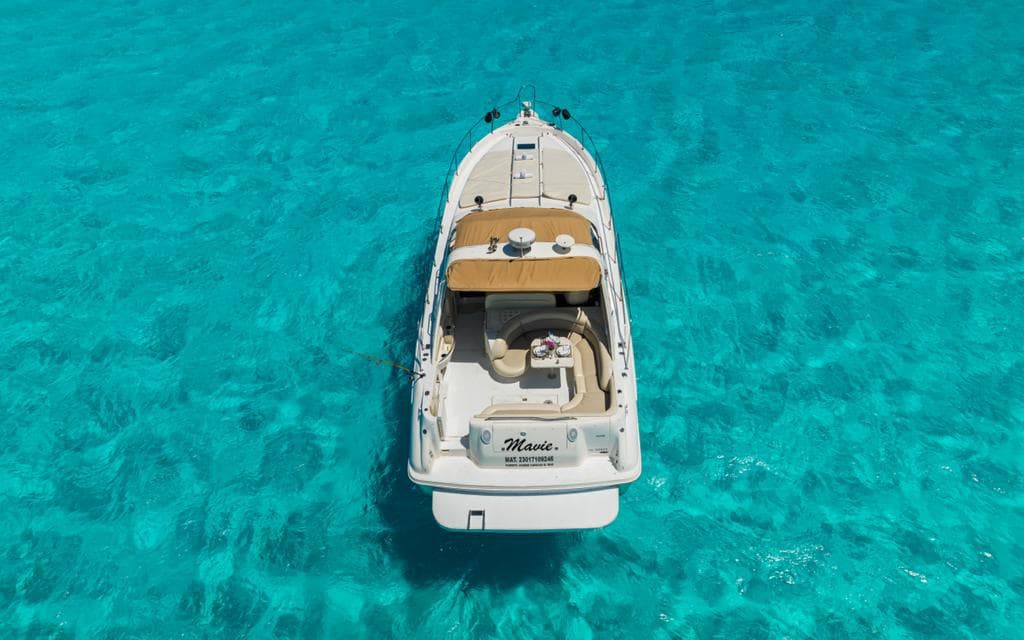 Aerial view of the yacht anchored over turquoise water.