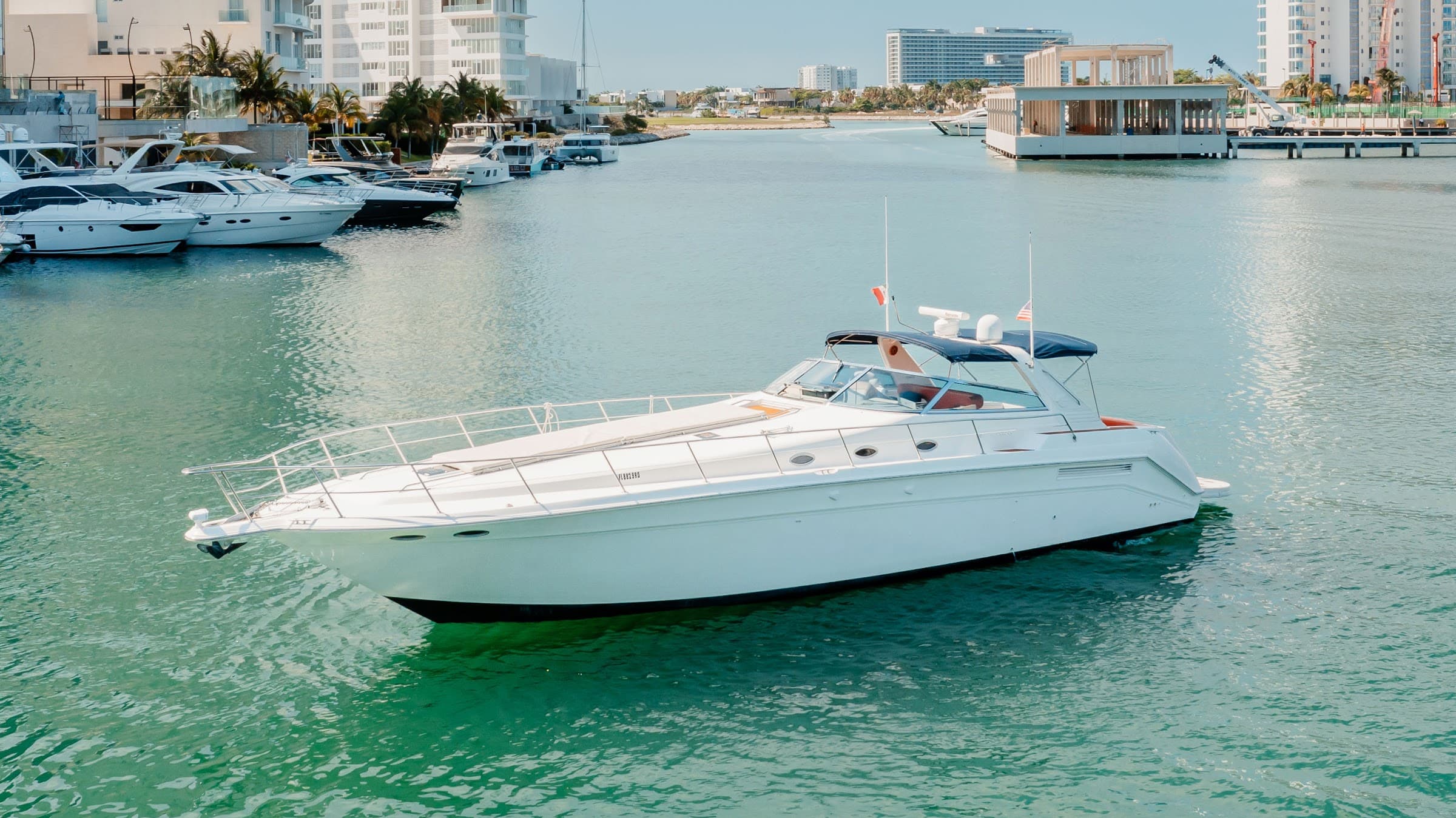 The yacht docked at the marina, seen from the side.