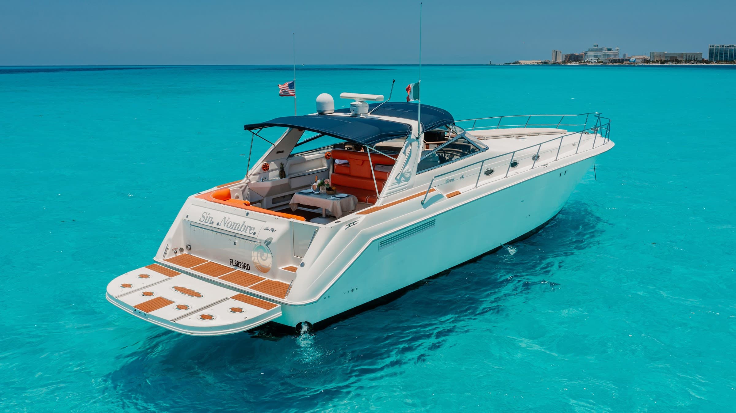 The yacht anchored in three quarters, with the cockpit in orange upholstery.