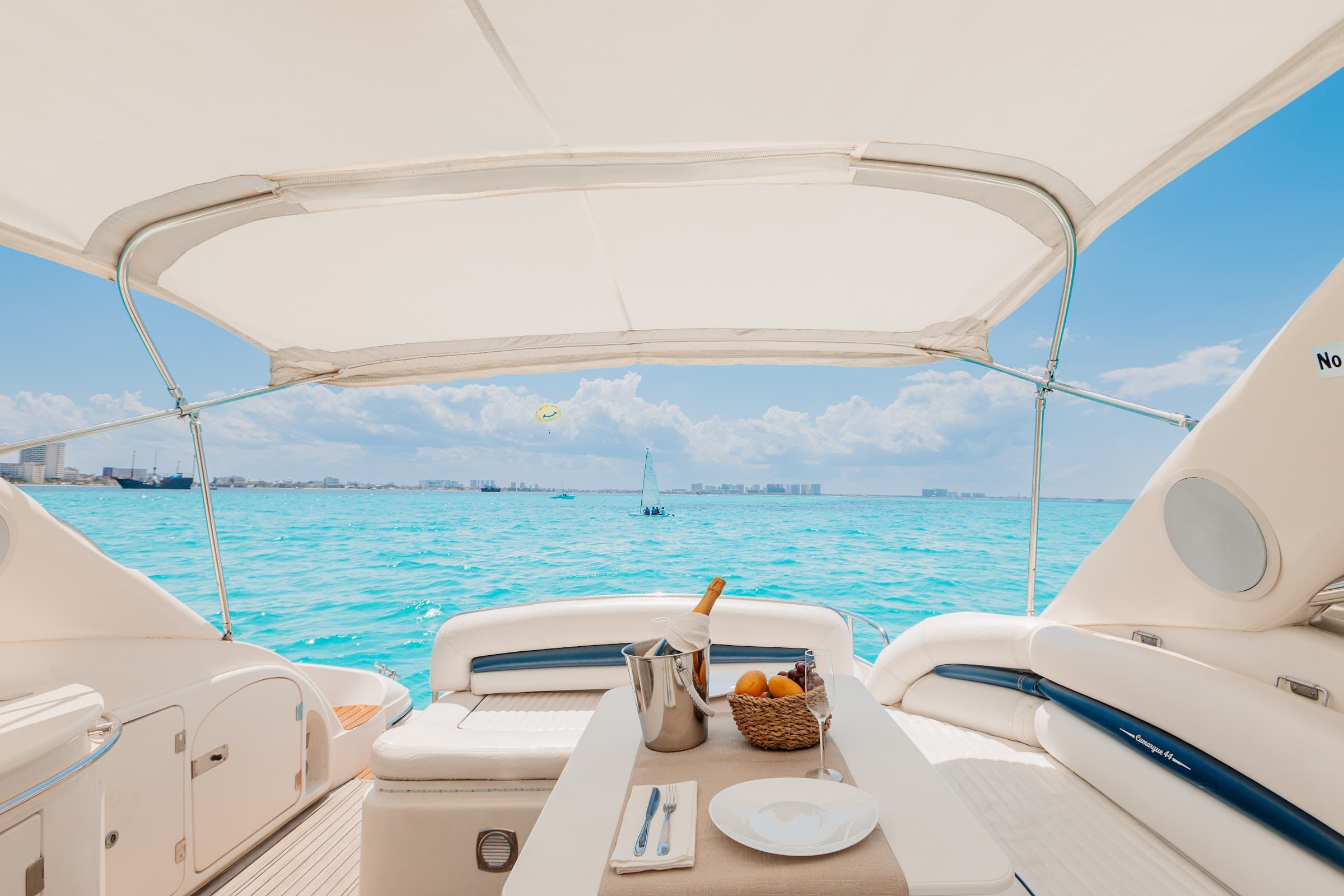 The bow facing the open sea, with a table and sunbathing area under the awning.