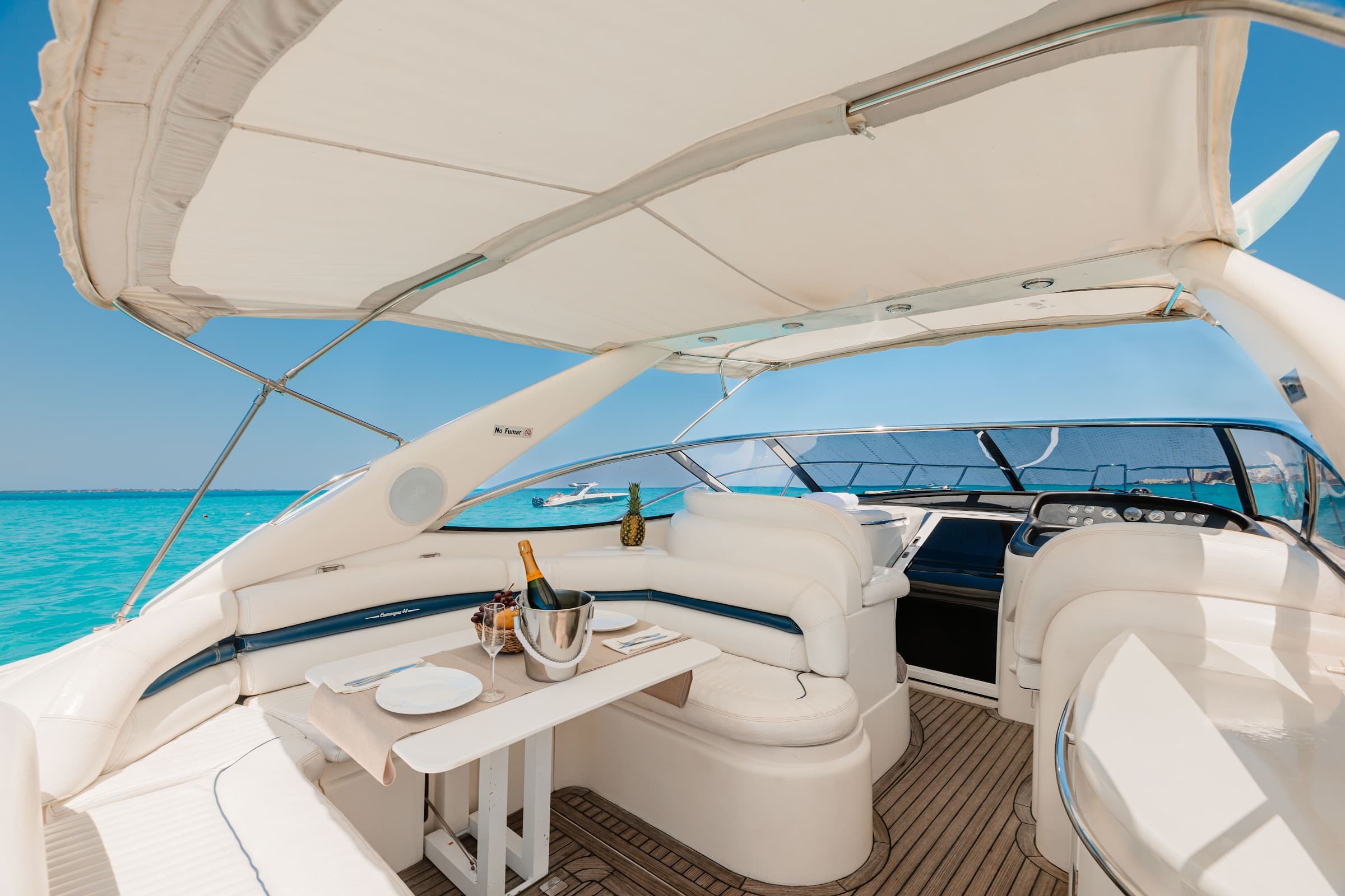 Bow deck with set table, cooler, and shade awning.