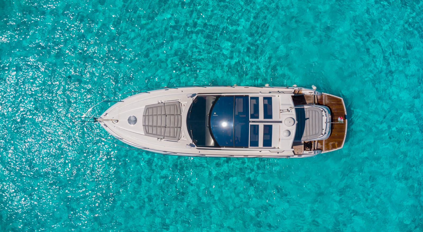 The yacht from above: bow deck with sunbathing areas and stern cockpit.