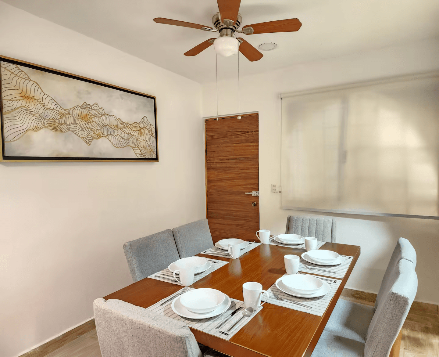 Dining room with a wooden table set for four.