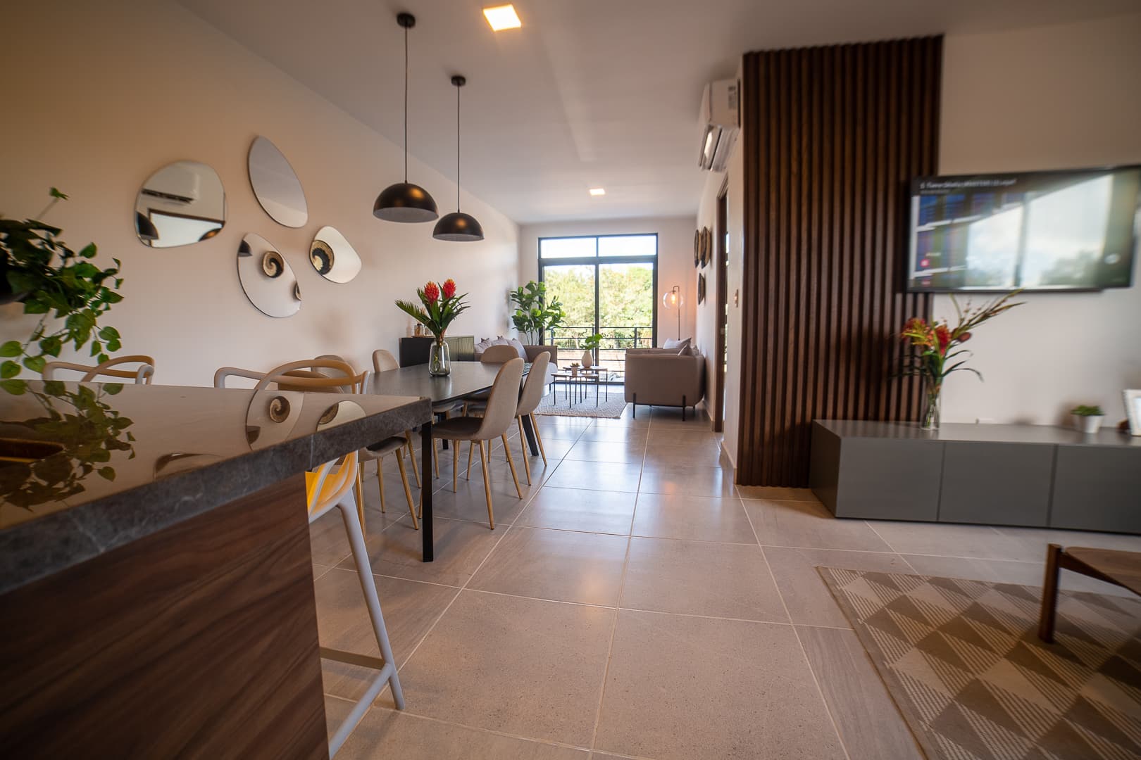 Breakfast bar with high chairs and the living room in the back.